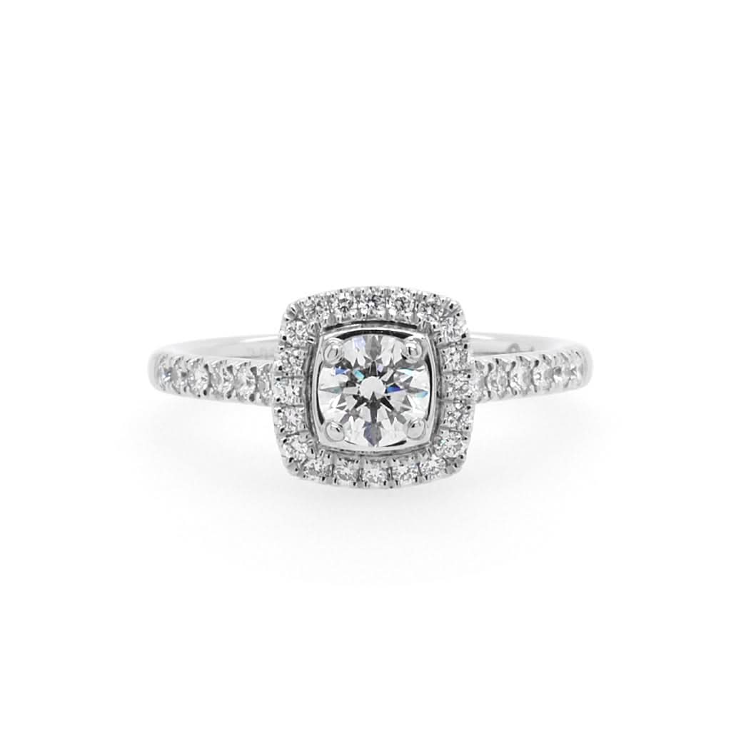 A brilliant cut diamond cluster ring with diamond set shoulders in platinum