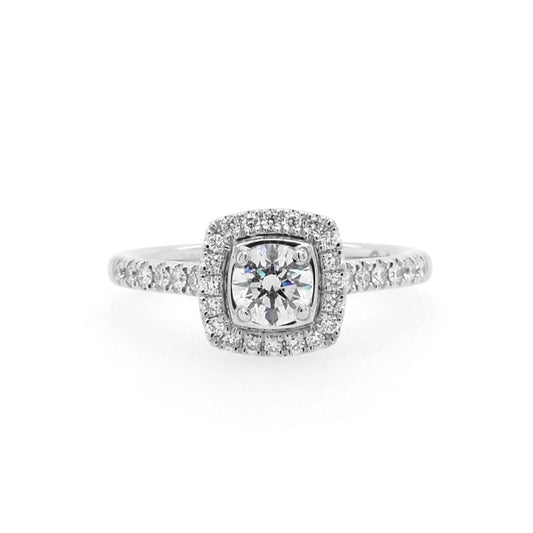 A brilliant cut diamond cluster ring with diamond set shoulders in platinum