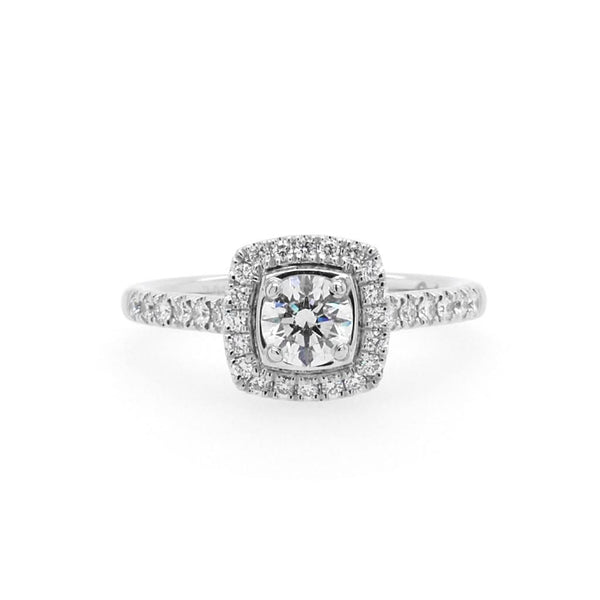 A brilliant cut diamond cluster ring with diamond set shoulders in platinum