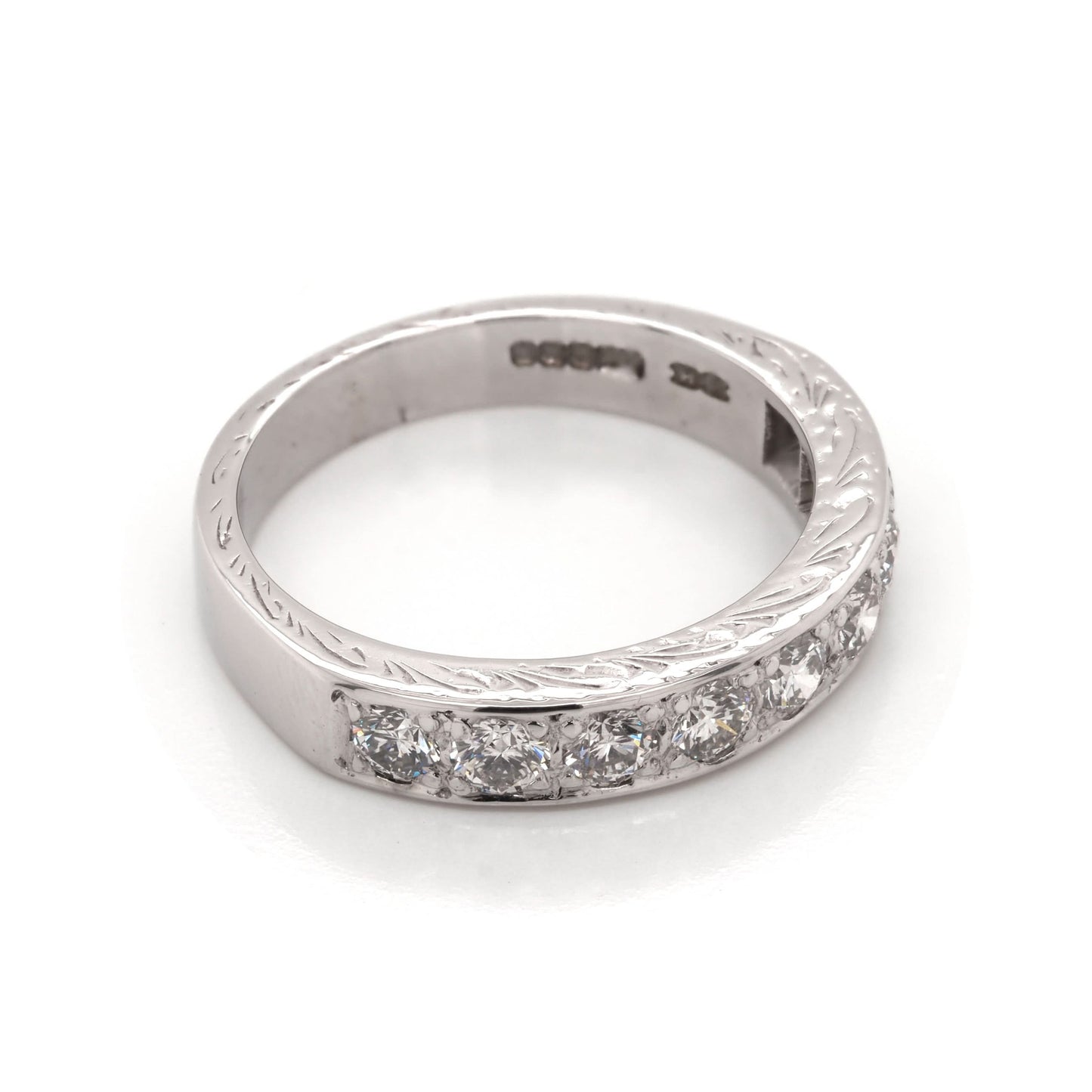 A white gold diamond half eternity ring with engraving