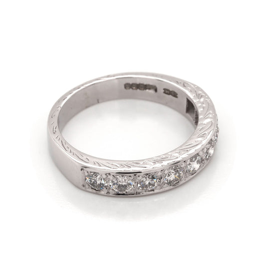A white gold diamond half eternity ring with engraving