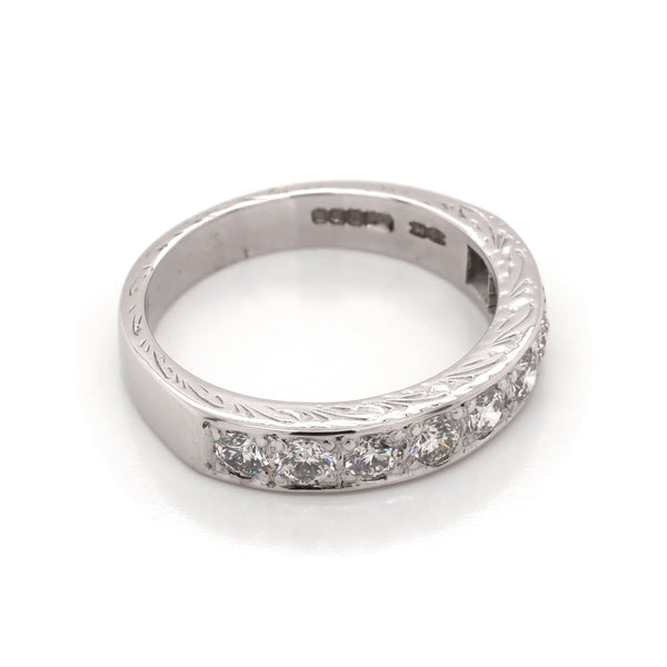 A white gold diamond half eternity ring with engraving