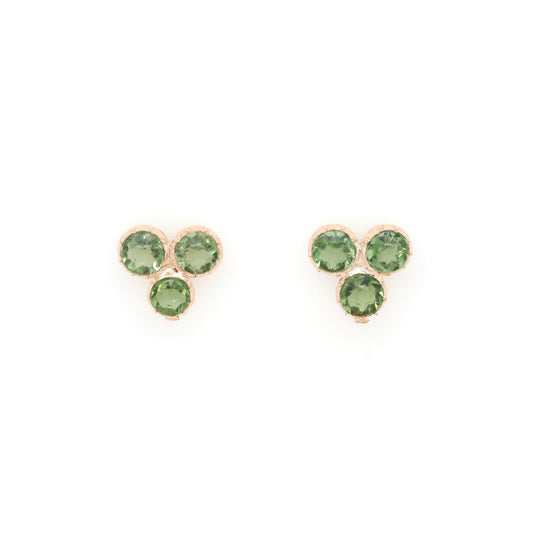 A pair of three stone peridot earrings in yellow gold