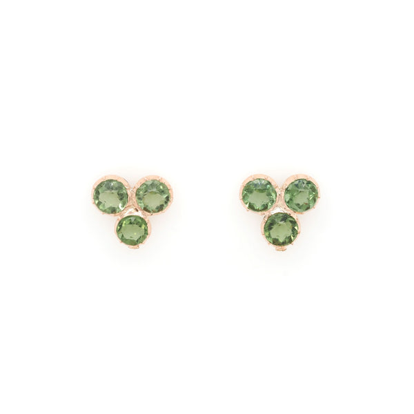 A pair of three stone peridot earrings in yellow gold