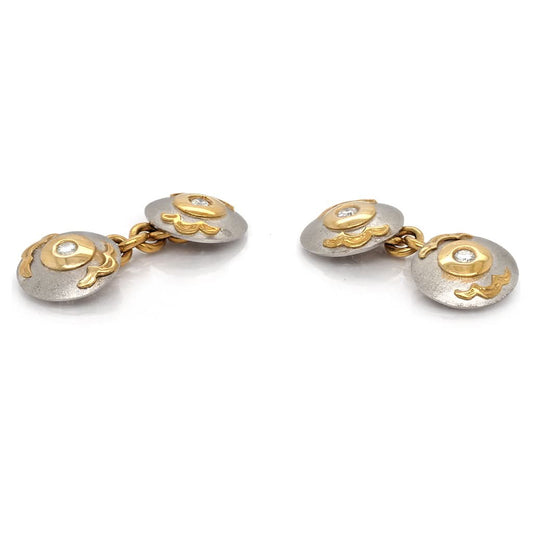 A pair of circular cufflinks in platinum and yellow gold with diamond centres