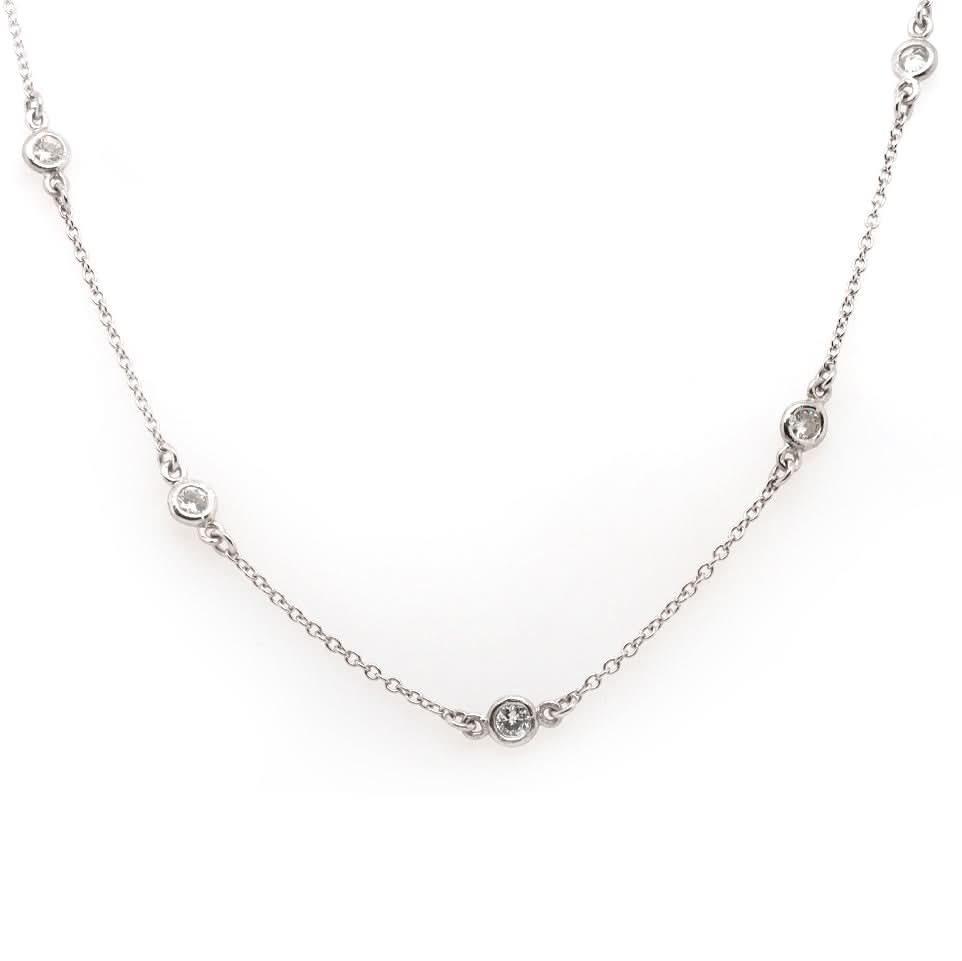 A platinum station chain necklace with brilliant cut diamonds