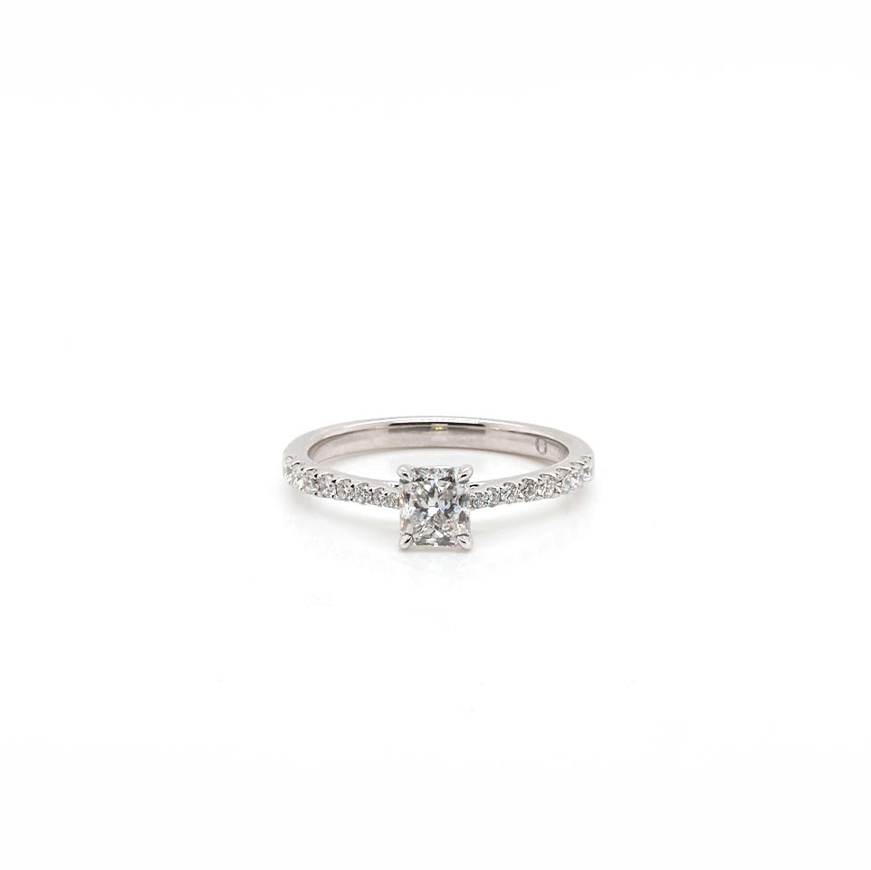 A platinum diamond ring with a radiant cut diamond centre and brilliant cut diamond shoulders