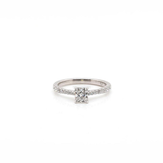 A platinum diamond ring with a radiant cut diamond centre and brilliant cut diamond shoulders