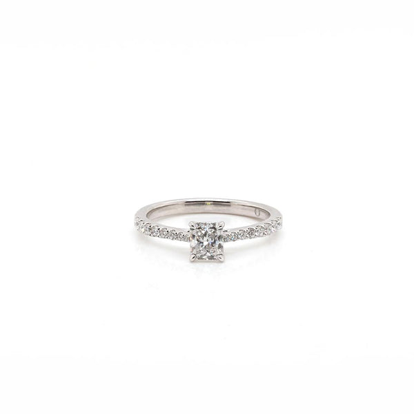 A platinum diamond ring with a radiant cut diamond centre and brilliant cut diamond shoulders