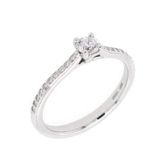 A platinum brilliant cut diamond solitaire ring with diamond set shoulders