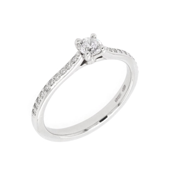 A platinum brilliant cut diamond solitaire ring with diamond set shoulders