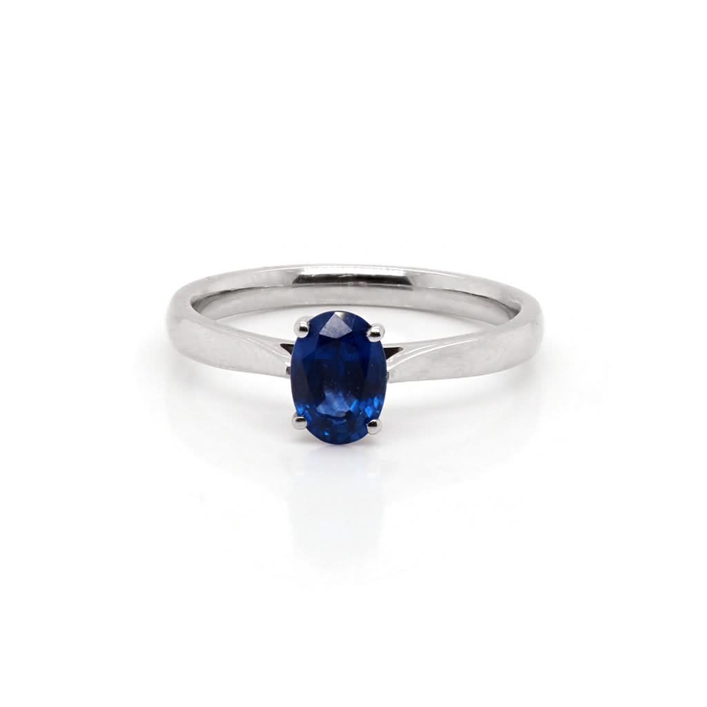 A single stone oval sapphire ring mounted in platinum