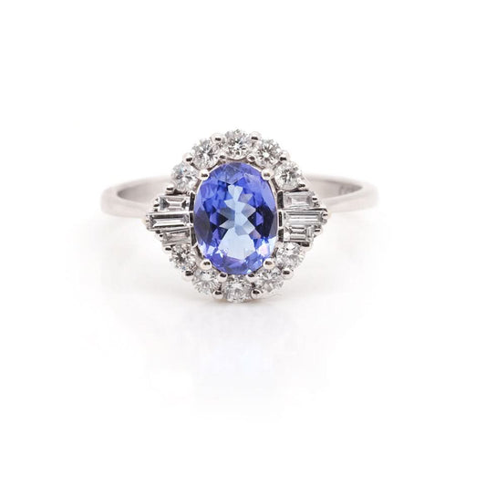 An oval cluster ring with an oval tanzanite centre and a diamond halo surround