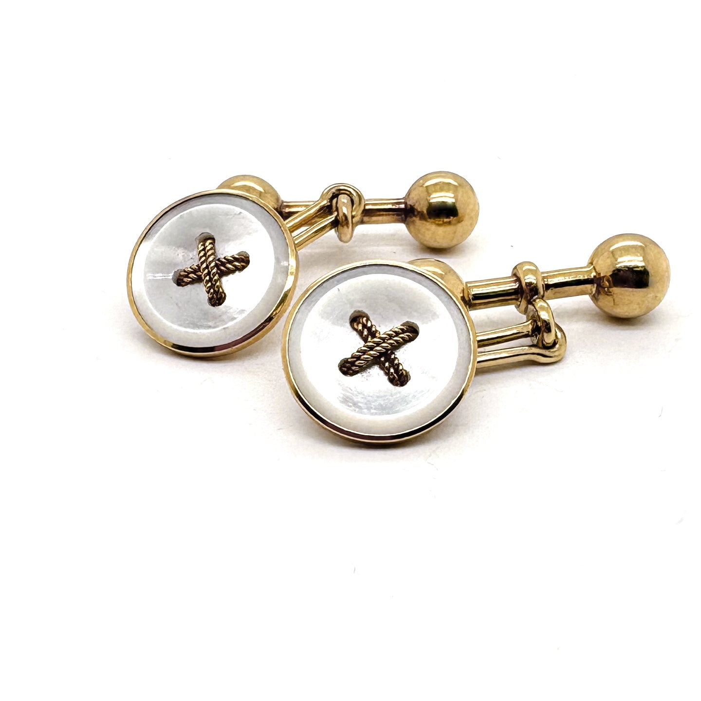 A pair of button design cufflinks in yellow gold