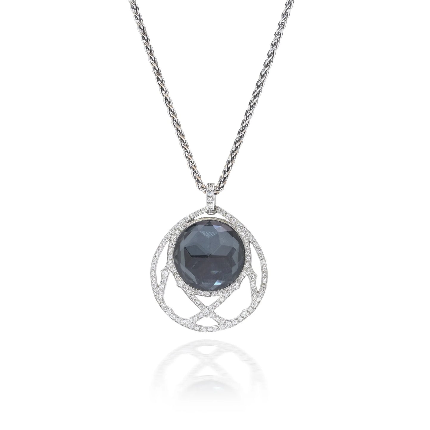 A dark crystal and white diamond pendant with a white gold chain