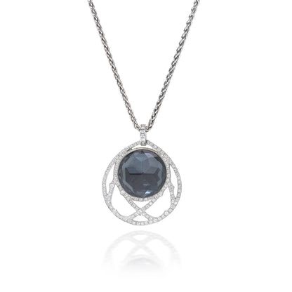 A dark crystal and white diamond pendant with a white gold chain