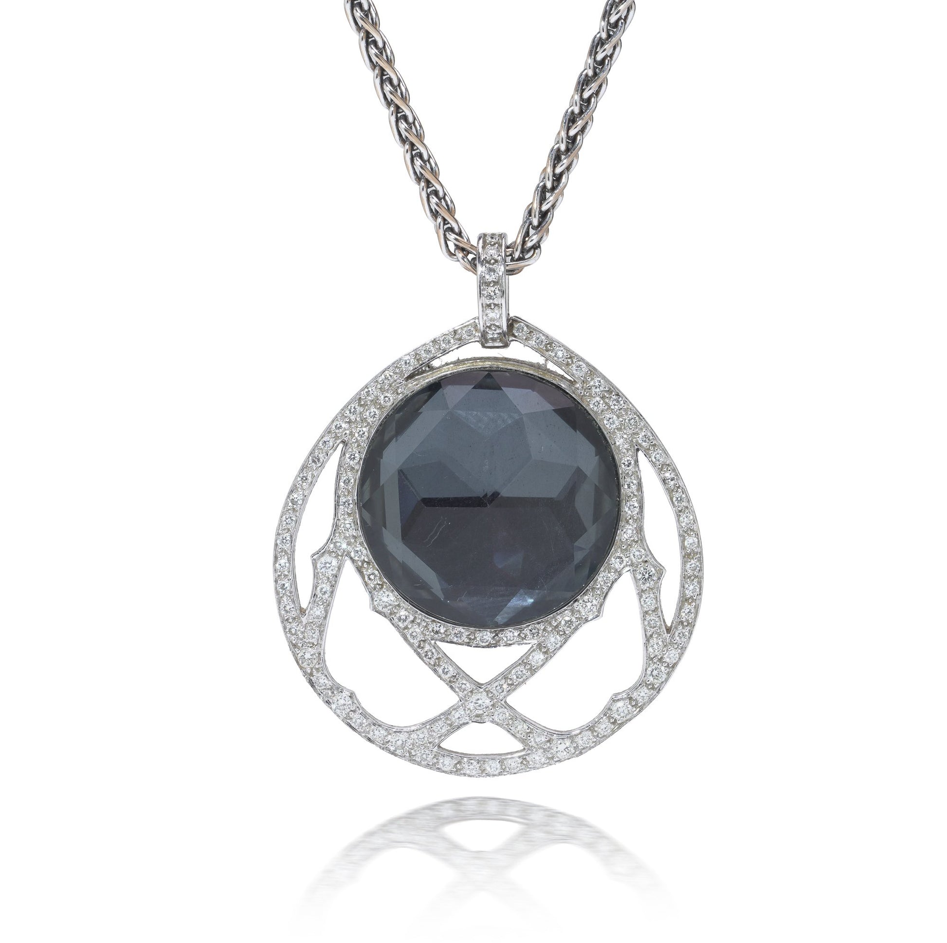 A dark crystal and white diamond pendant with a white gold chain