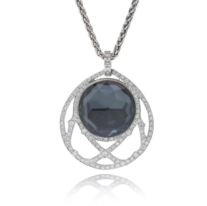 A dark crystal and white diamond pendant with a white gold chain