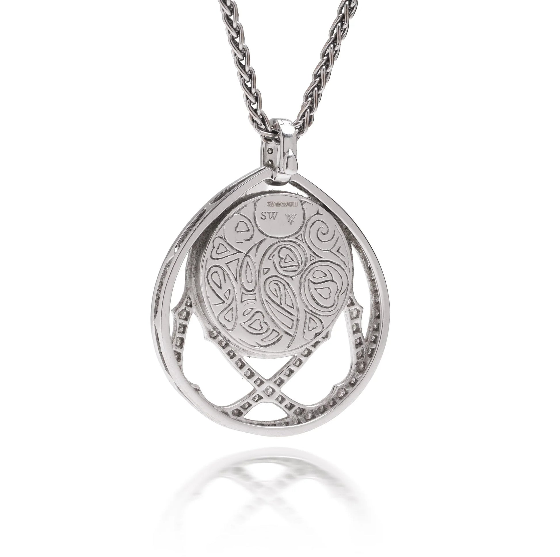 A white gold pendant, engraved on the back, with a white gold chain
