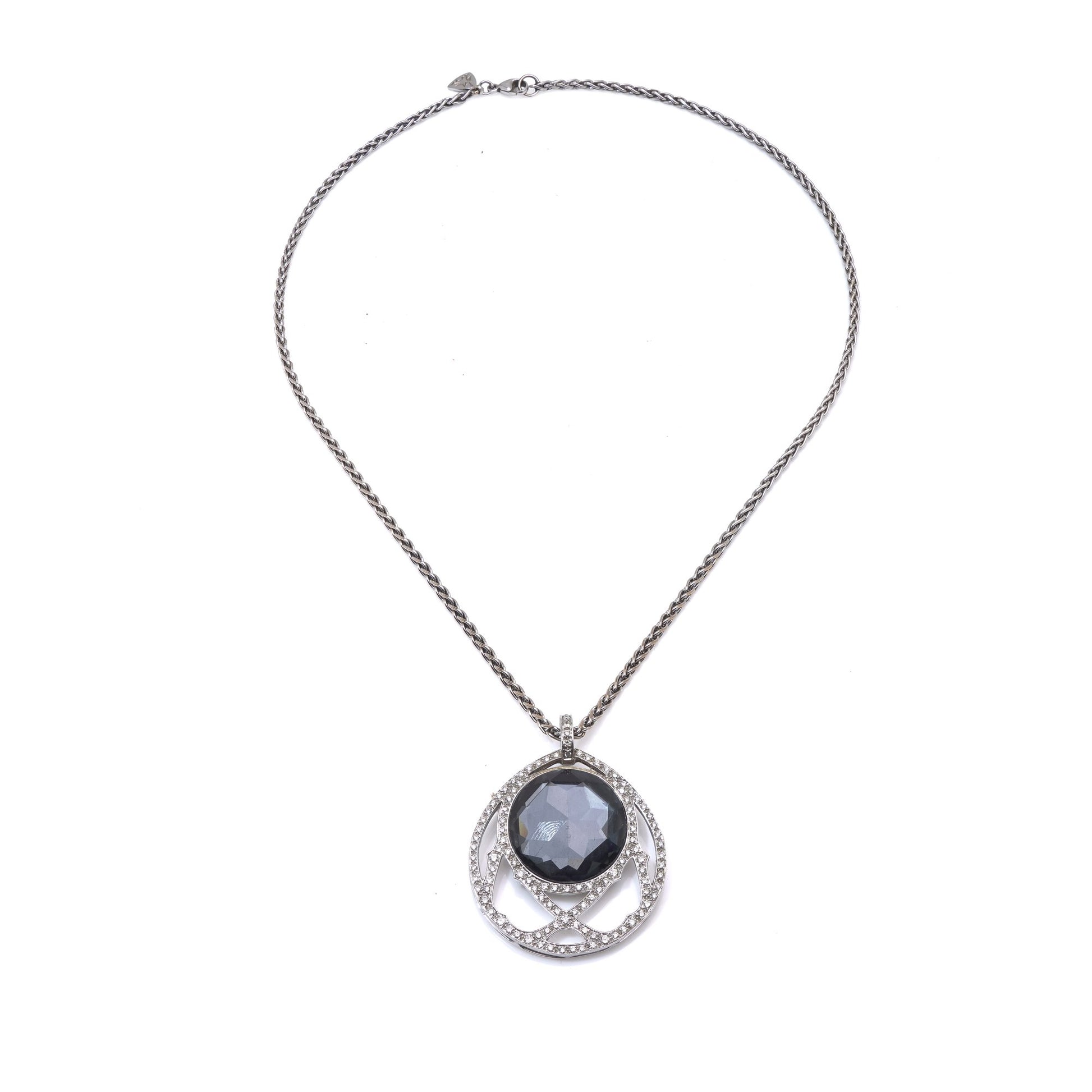 A dark crystal and white diamond pendant with a white gold chain