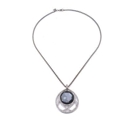 A dark crystal and white diamond pendant with a white gold chain