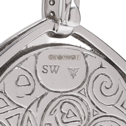Close-up of an 18 carat gold hallmark and SW stamp on an engraved pendant