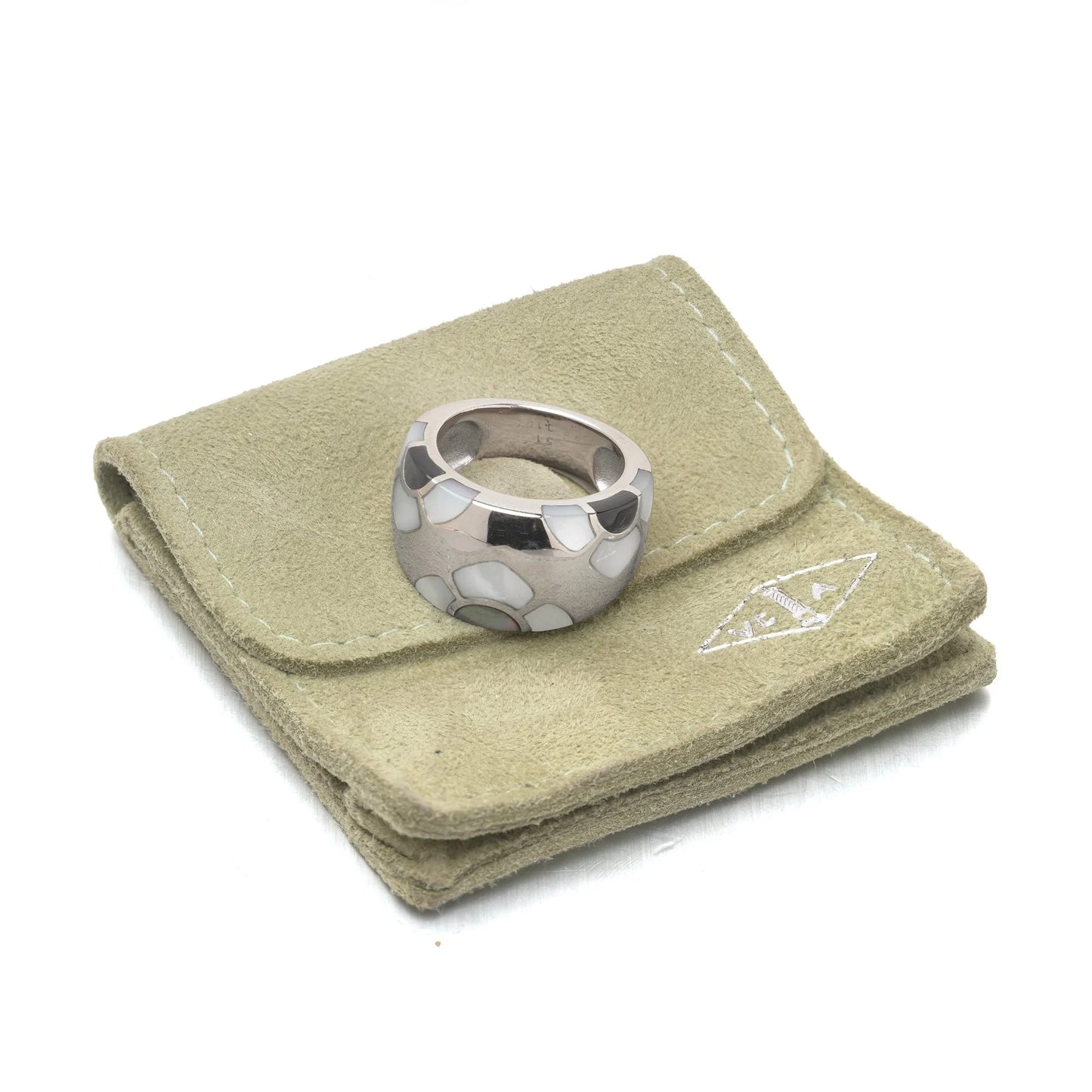 A white gold band ring with mother of pearl inlays, on a VCA pouch