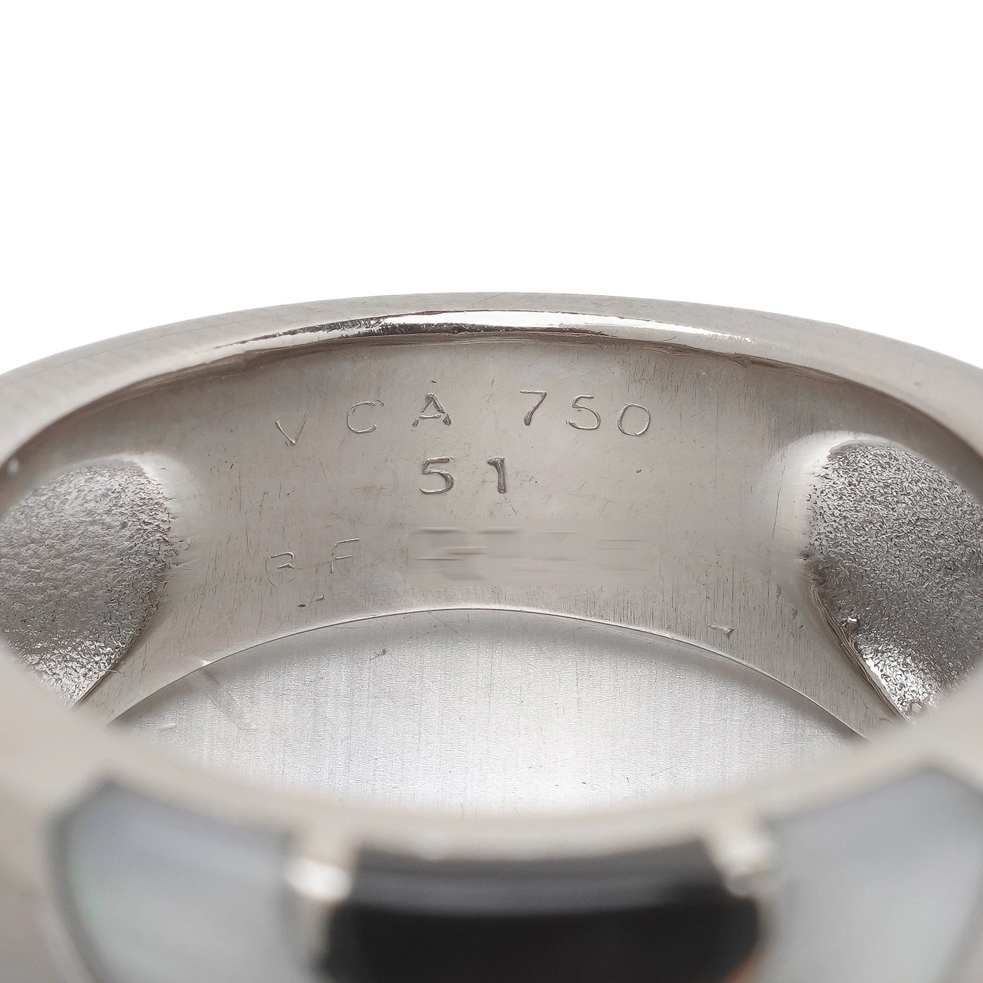 Close-up of a VCA 750 51 stamp inside a white gold ring shank