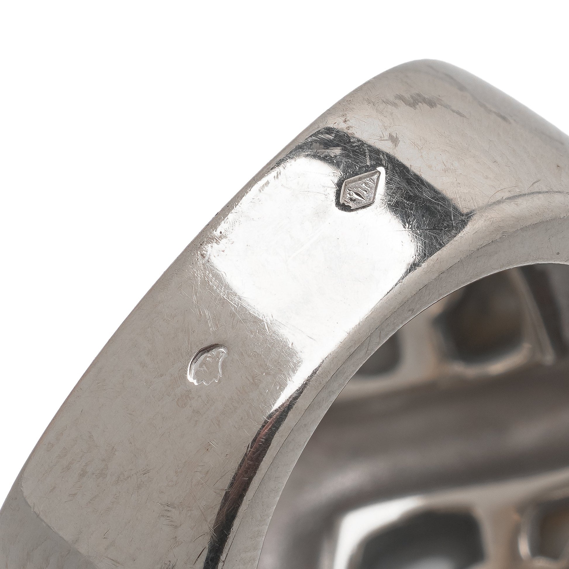 Close-up of French stamps on a white gold ring shank