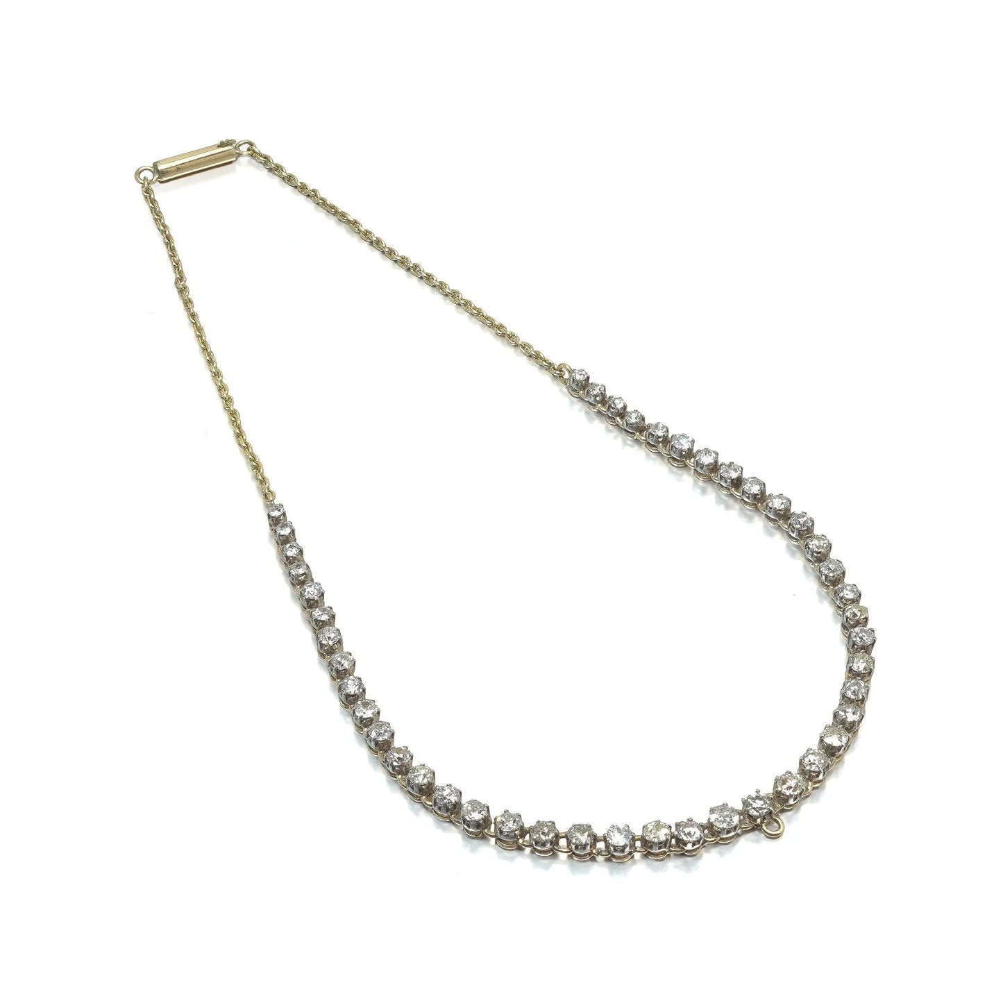 An antique diamond riviere necklace in yellow gold