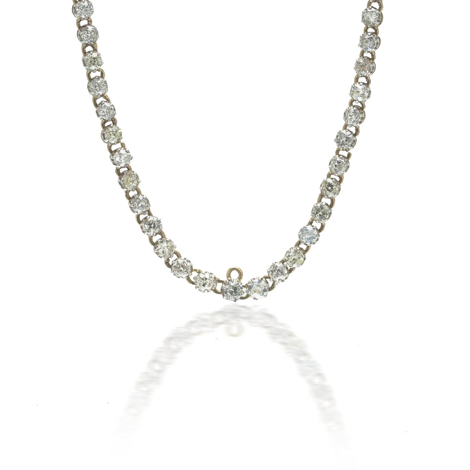 An antique diamond riviere necklace in yellow gold