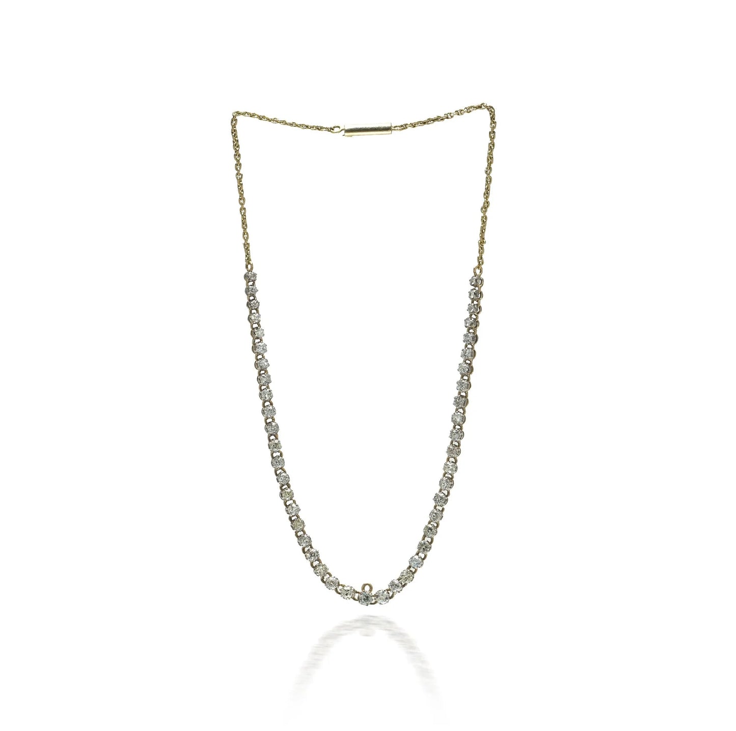 An antique diamond riviere necklace in yellow gold