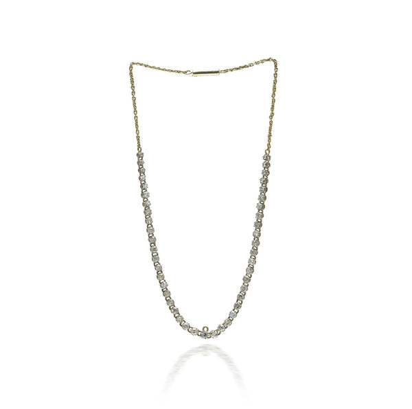 An antique diamond riviere necklace in yellow gold
