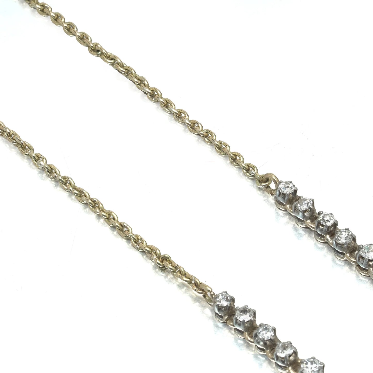 An antique diamond riviere necklace in yellow gold
