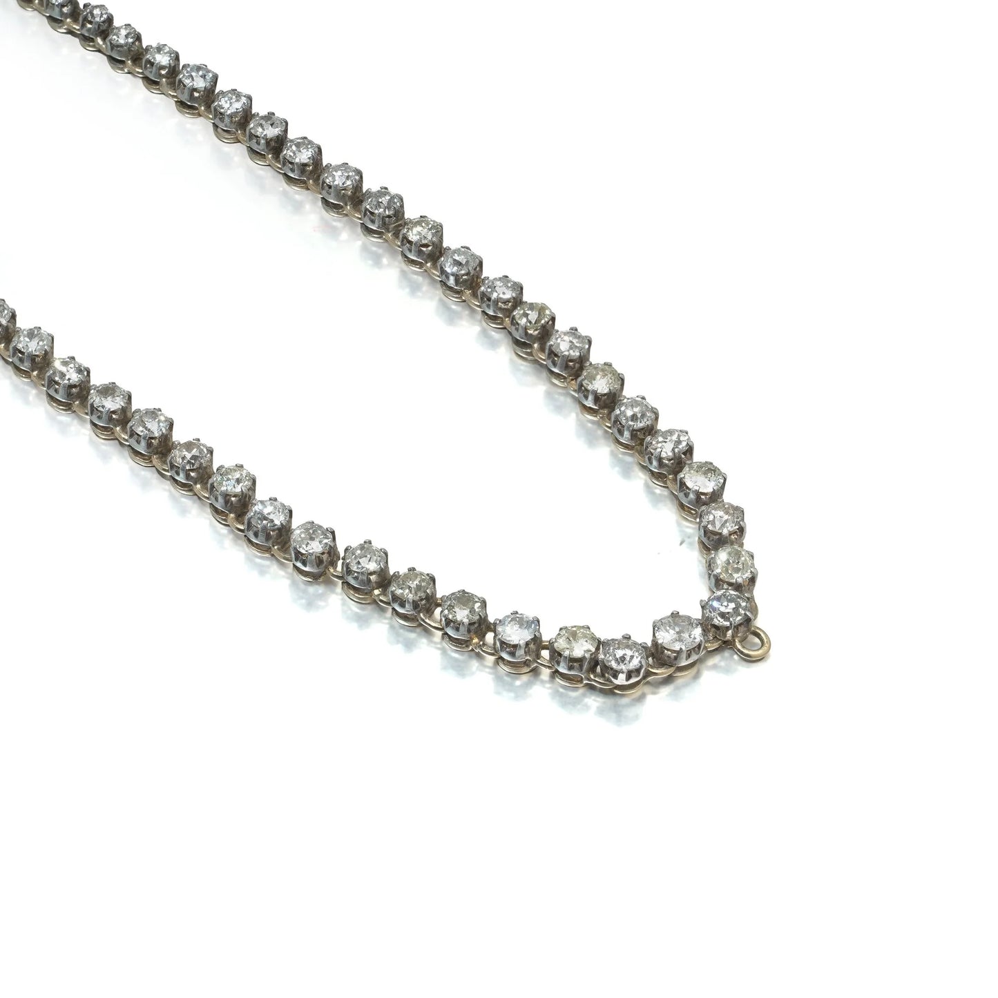 An antique diamond riviere necklace in yellow gold