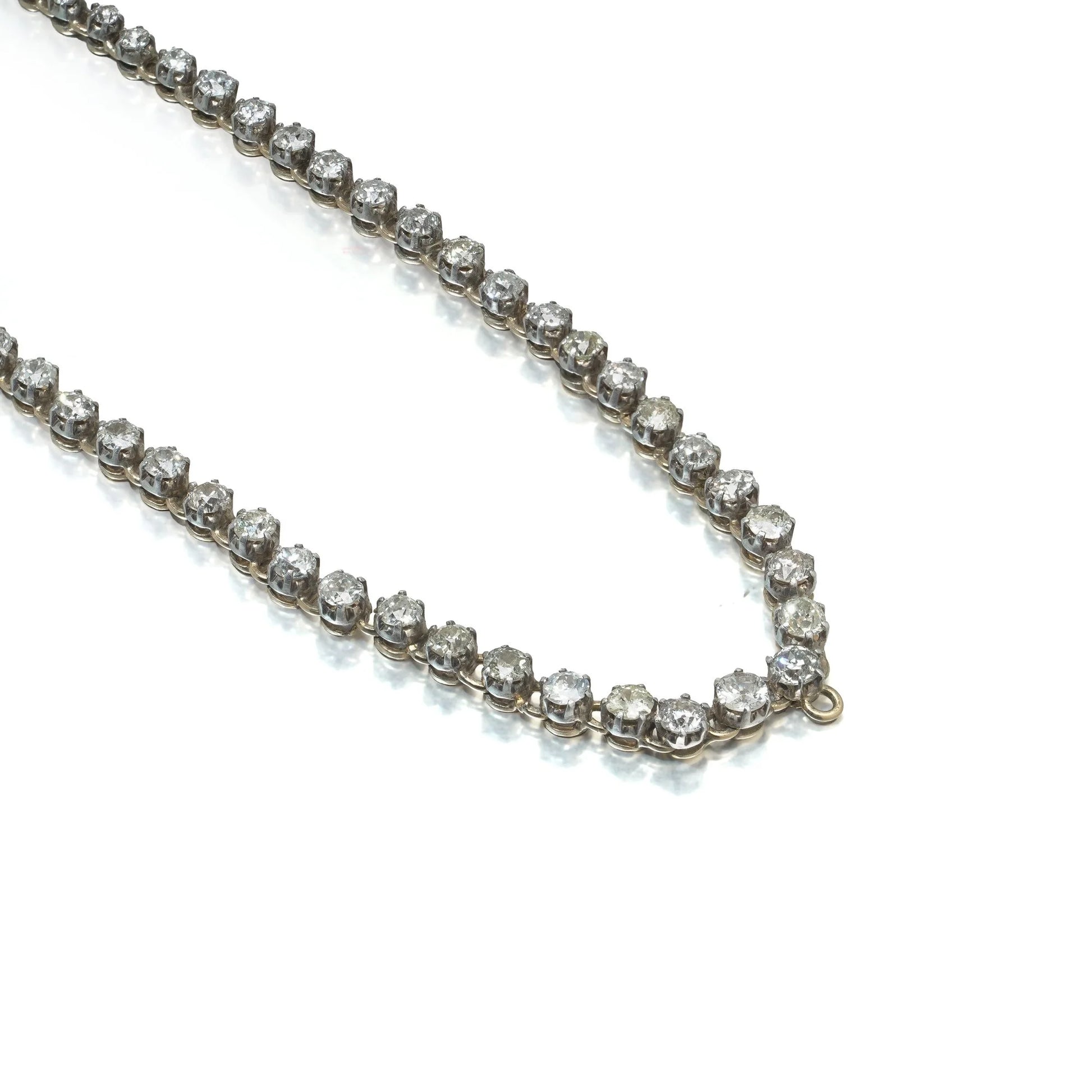 An antique diamond riviere necklace in yellow gold