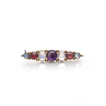 A cabochon multi-gemstone bar brooch in yellow gold