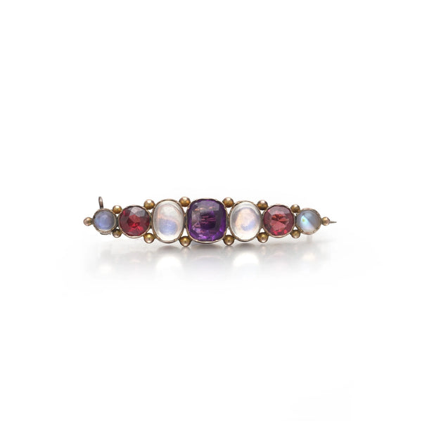 A cabochon multi-gemstone bar brooch in yellow gold
