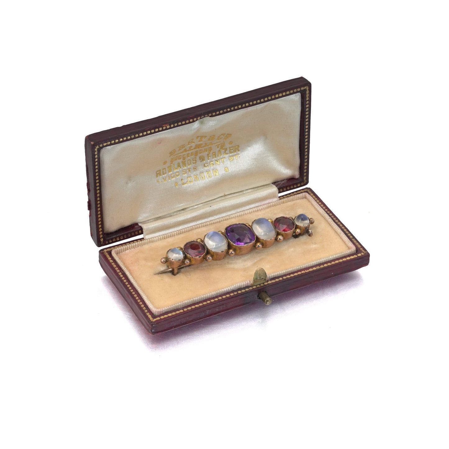 A cabochon multi-gemstone bar brooch in yellow gold, in an antique box