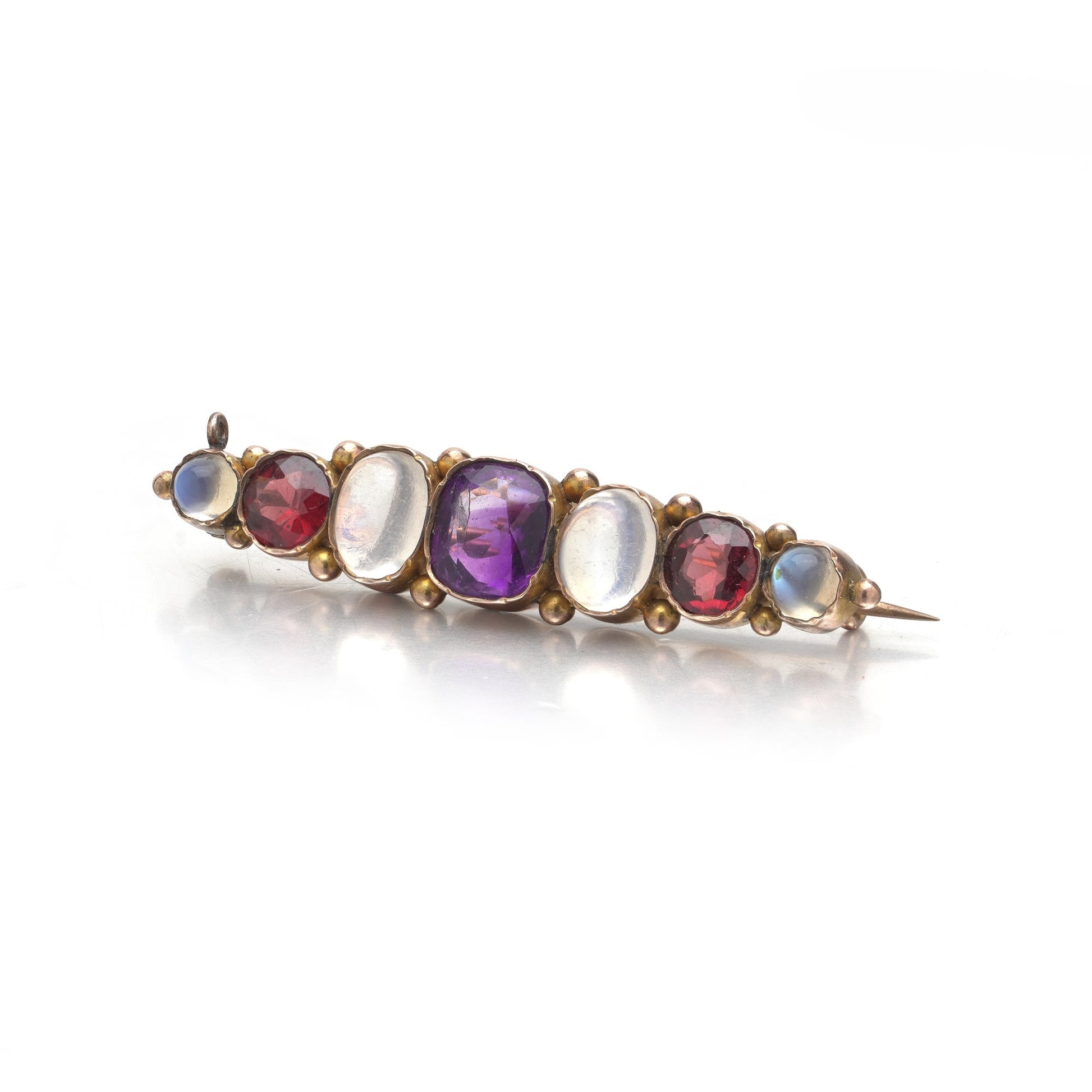 A cabochon multi-gemstone bar brooch in yellow gold