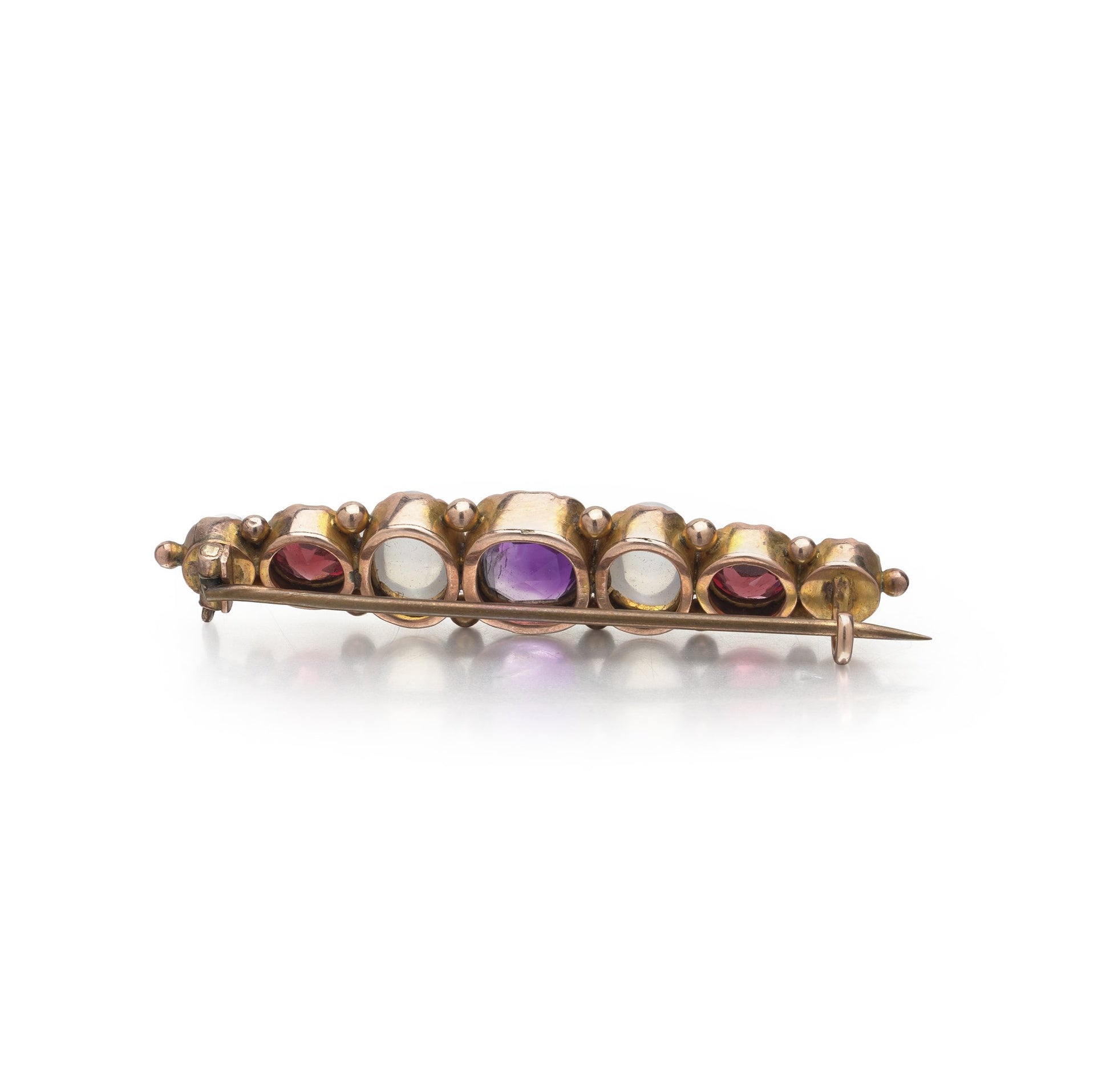 A cabochon multi-gemstone bar brooch in yellow gold
