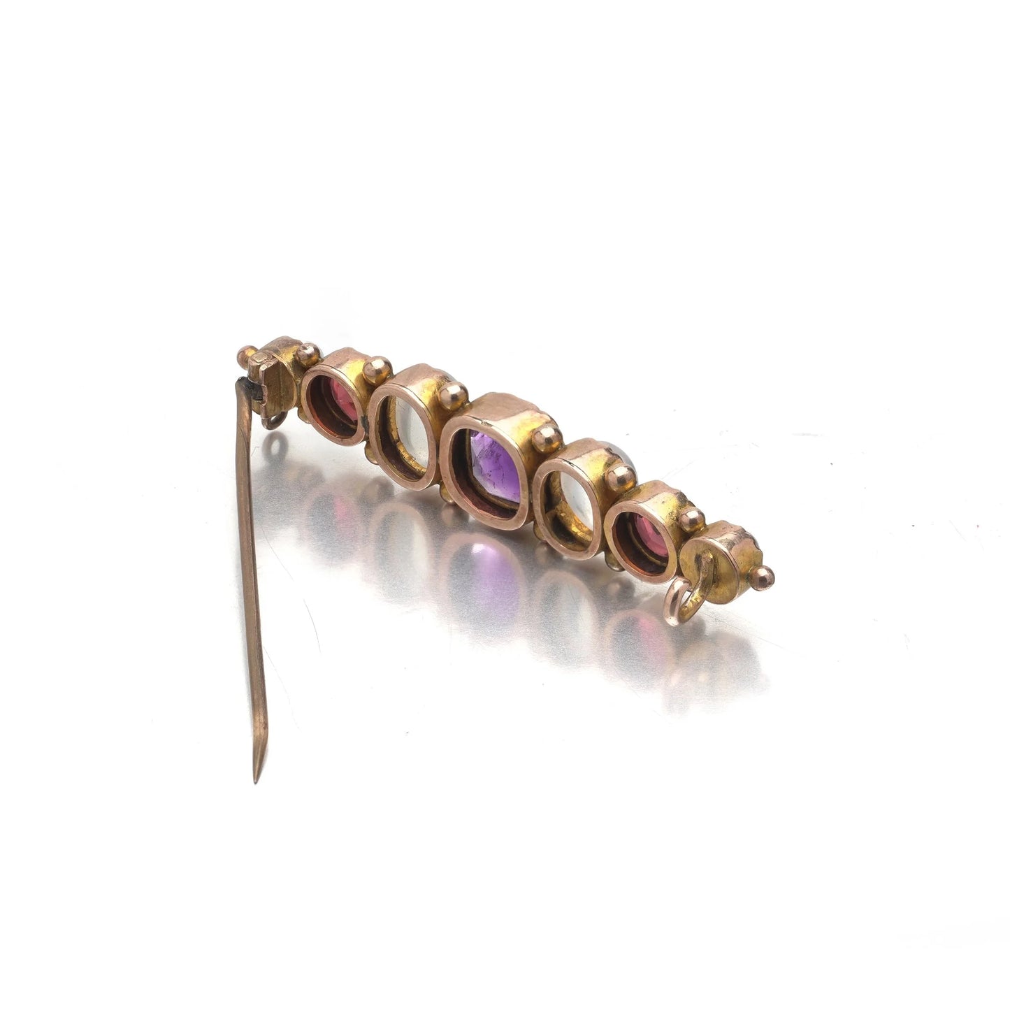 A cabochon multi-gemstone bar brooch in yellow gold