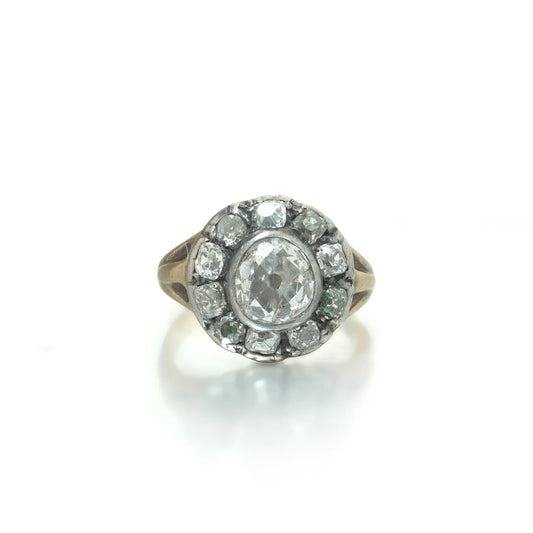 An antique diamond cluster ring in yellow gold and silver