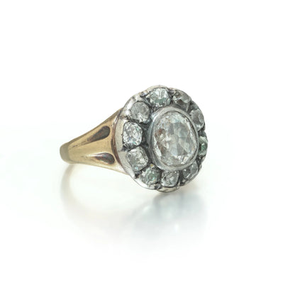 An antique diamond cluster ring in yellow gold and silver