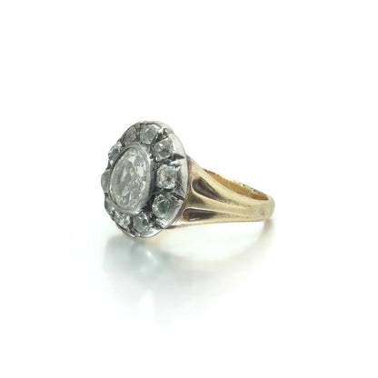 An antique diamond cluster ring in yellow gold and silver