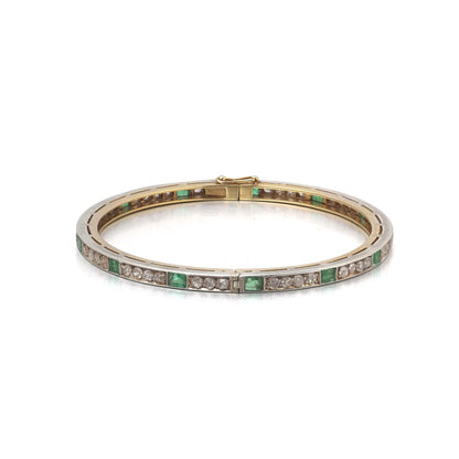 A square emerald and round diamond set bangle bracelet in yellow gold and silver