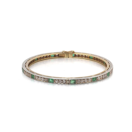 A square emerald and round diamond set bangle bracelet in yellow gold and silver