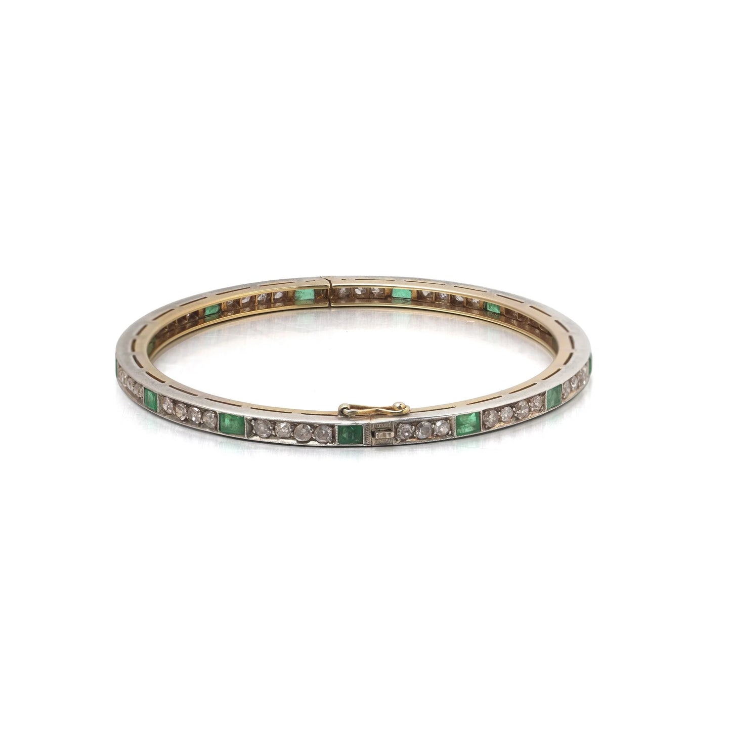 A square emerald and round diamond set bangle bracelet in yellow gold and silver