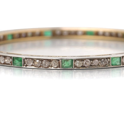 A square emerald and round diamond set bangle bracelet in yellow gold and silver