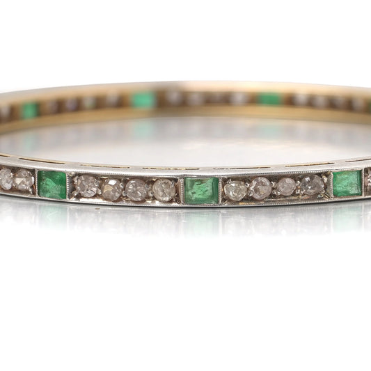 A square emerald and round diamond set bangle bracelet in yellow gold and silver